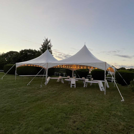 20X40 60 Person High Peak Frame Tent Package at dusk 