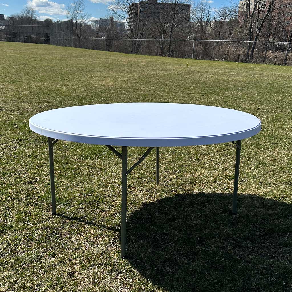 5FT Round Plastic Table Rental Massachusetts on Grass